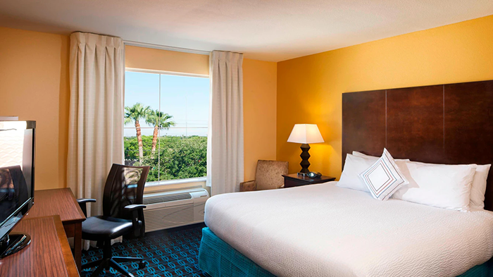 One of the many guest rooms at the Fairfield Inn & Suites Houston Intercontinental Airport hotel. The walls are painted yellow.