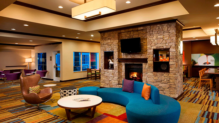 A common area at the Fairfield Inn & Suites Houston Intercontinental Airport hotel. The room is quite strikingly decorated.