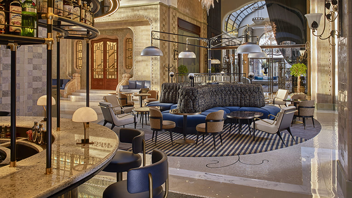 The lobby at the Four Seasons Hotel Gresham Palace Budapest, with a bar and plenty of comfortable seating.