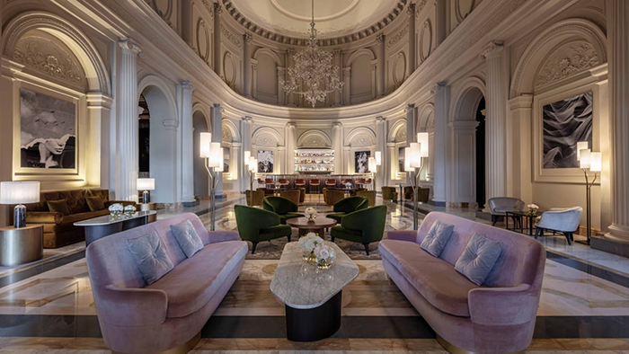 A common seating area inside the Anantara Palazzo Naiadi Rome Hotel. The room has an incredibly elegant feel.