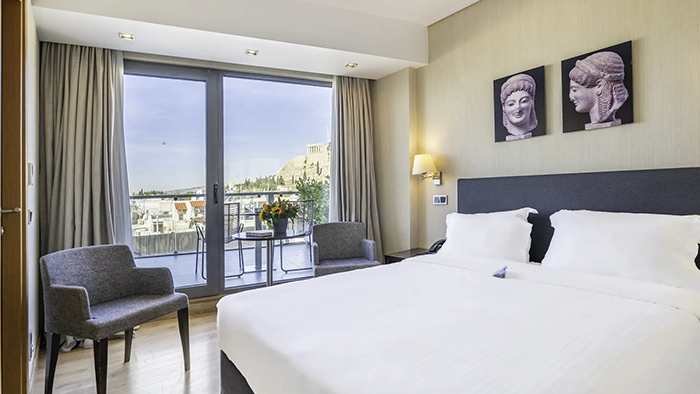 A guest room at the Athens Gate Hotel. There's a balcony just through a glass door with a stunning view of the Acropolis.