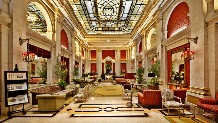 The lobby of the Avenida Palace hotel in Lisbon, Portugal. The room is vast and ornate.