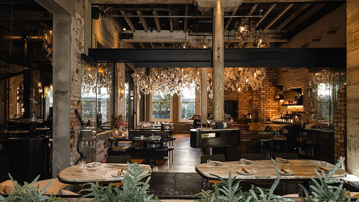 A restaurant inside The Hotel Britomart. The decor is rugged; with exposed brick, metal, and concrete.