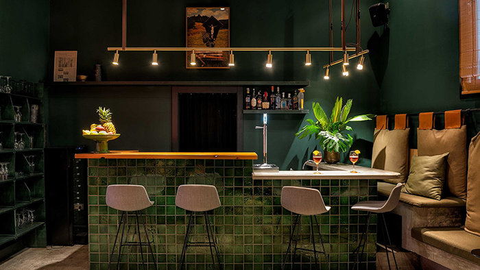 A bar inside the Hotel Brummell in Barcelona. The room is decorated with multiple shades of green.