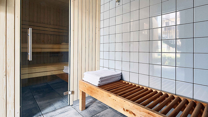 A sauna inside the Hotel Brummell in Barcelona, Spain. A stack of three towels awaits the next guests outside the steam room.