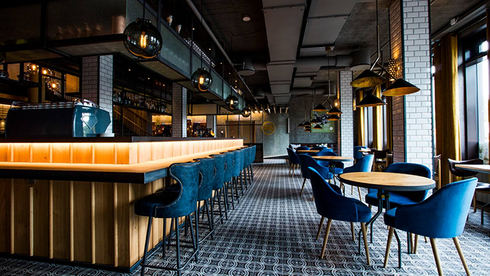 A bar inside the Canopy by Hilton Reykjavik City Centre. The floor is decorated by beautiful tiles.