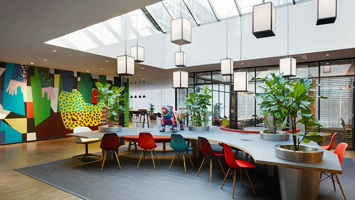 A common area inside the citizenM Rotterdam hotel. This large room features a large desk ideal for getting a bit of work done.