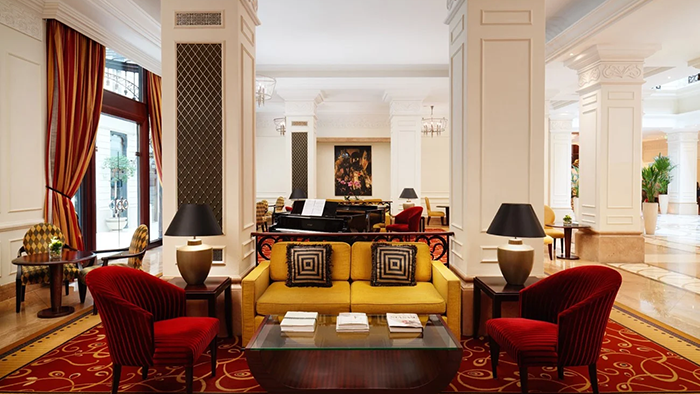 A common area in The Corinthia Budapest Hotel. Plenty of comfortable seating is avaiable, and a coffee table holds up four large books waiting to be read.