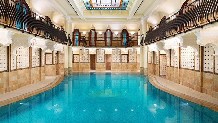 The Corinthia Budapest Hotel's indoor pool. A balcony surrounds the water one floor up that's ideal for jumping off of; though the hotel staff would likely not approve of such a stunt.