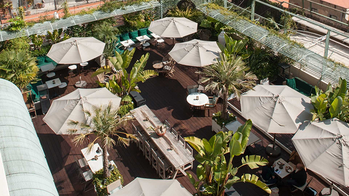 The rooftop seating area at the Autograph Collection Cotton House Hotel. Umbrellas are available to protect guests from the Spanish sun.
