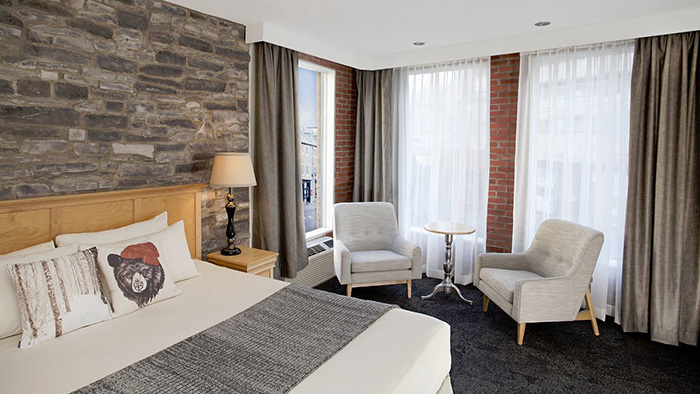 One of the Htel du Vieux-Qubec's guest rooms. The walls feature two different kinds of exposed brick.