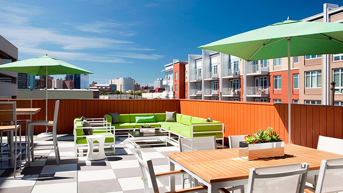 An outdoor common area at the Element Harrison Newark hotel. The Newark cityscape is visible in the background.