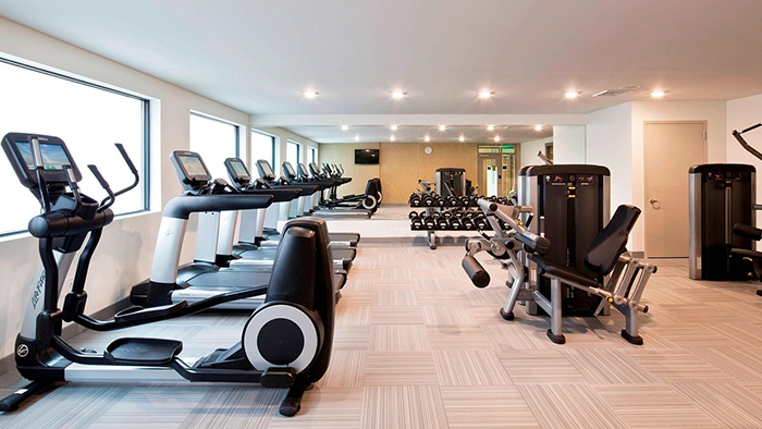 The fitness center (also known as the gym) at the Element Harrison Newark hotel. A variety of fitness equipment is available, including free weights.