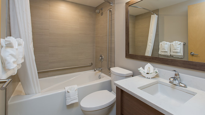 A bathroom attached to a guest room at the Embassy Inn Hotel in Victoria.