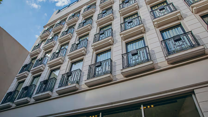 The facade of the Esplendor by Wyndham Buenos Aires Tango Hotel. It's covered in french balconies.