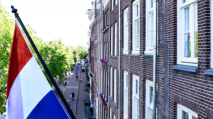 The Hotel Estherea's facade, where the Flag of the Netherlands hangs proudly.