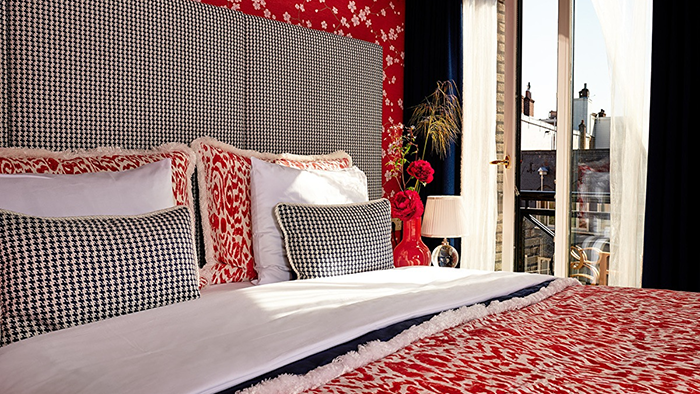 A guest room at the Hotel Estherea in Amsterdam. The historic Dutch city is visible through the window.