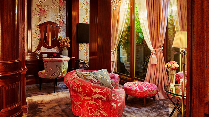 A guest suite at the Hotel Estherea in Amsterdam. A wide variety of shades of red give the room a romantic feel.