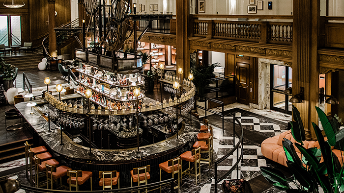 The bar area inside the Fairmont Olympic Hotel in Seattle. A wooden sculpture stands tall above the bar itself.