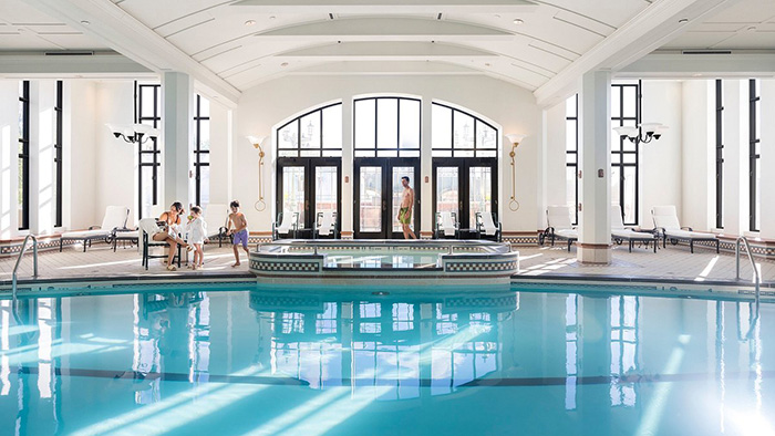 A family enjoying the Fairmont Le Chteau Frontenac's indoor pool area. Interestingly, nobody is actually in the pool.