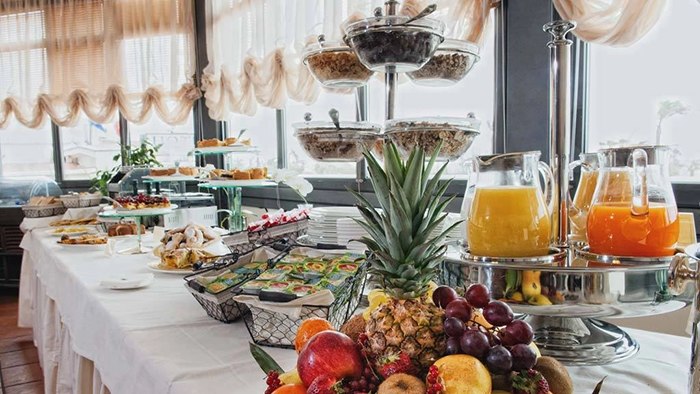Breakfast at the Hotel San Giorgio. A selection of fruits, pastries, cereals, and juices has been laid out.