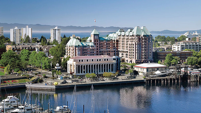 An exterior shot of the Hotel Grand Pacific in Victoria, British Columbia. The Steamship Terminal is partly obscuring the hotel's facade.