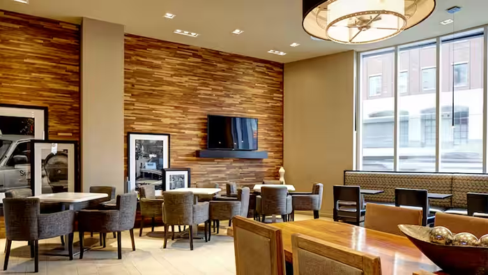A common area inside the Hampton Inn Brooklyn/Downtown hotel. Interestingly, framed pictures are simply resting against the wall instead of hanging.