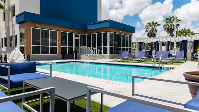 The pool area at Hampton Inn & Suites by Hilton Miami Airport South Blue Lagoon. The hotel is appropriately named: the pool is shockingly blue.
