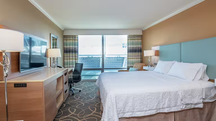 A guest room at the Hampton Inn & Suites by Hilton Vancouver-Downtown hotel. This one has a private balcony.