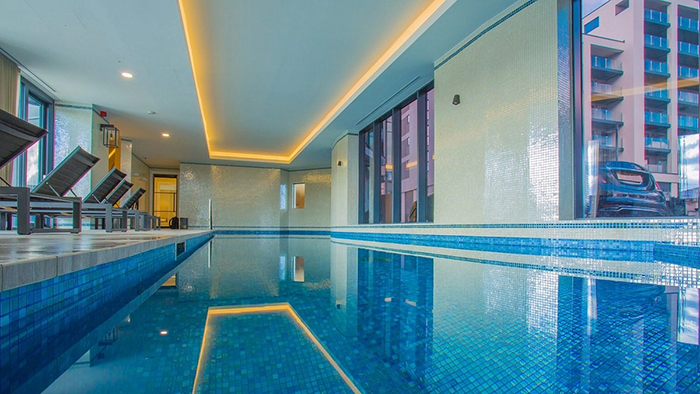 The Harbour Hotel Southampton's indoor pool. Warm, recessed lighting keeps the space lit during the darker hours.