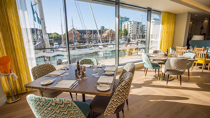 A restaurant inside the Harbour Hotel Southampton. Guests here are able to enjoy a great view of the harbour while they enjoy a meal.