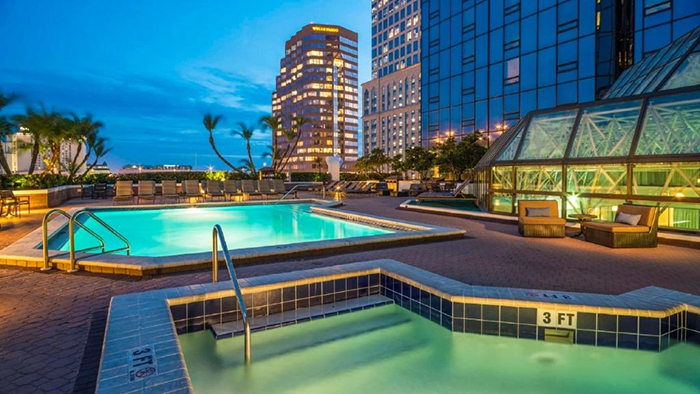 The rooftop pool at the Hilton Tampa Downtown. A small hot tub is visible in the foreground of the image.