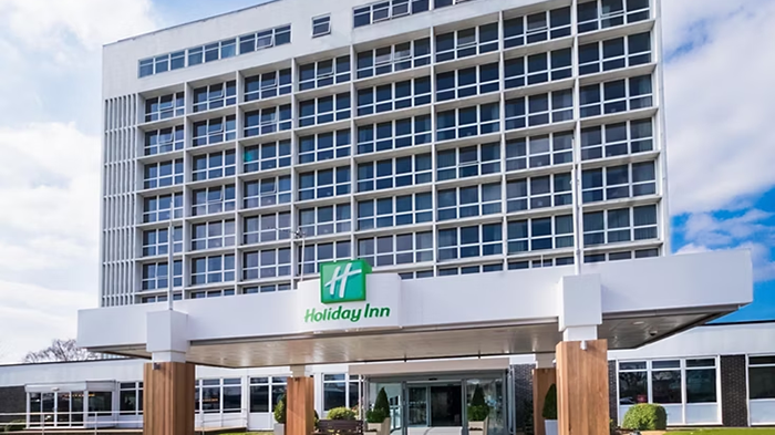 The outside of the Holiday Inn Southampton, an IHG Hotel. The green Holiday Inn logo is displayed prominently at the top of a large awning.