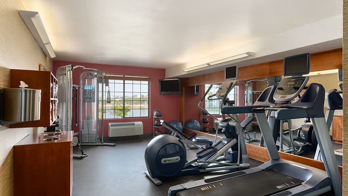 The gym inside the Homewood Suites by Hilton San Diego Airport-Liberty Station hotel. A variety of exercise machines are available.