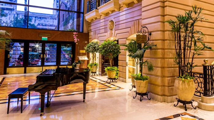 A section of the lobby at InterContinental Buenos Aires, an IHG Hotel. A baby grand piano sits at the center of the room.