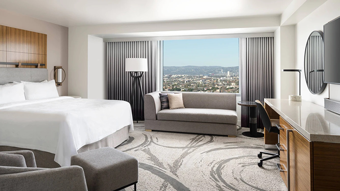A guest room at the JW Marriott Los Angeles L.A. LIVE hotel. A beautiful view of the City of Angels can be seen through the window.