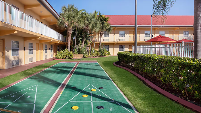 A pair of outdoor shuffleboard courts at the La Quinta Inn by Wyndham Cocoa Beach-Port Canaveral.