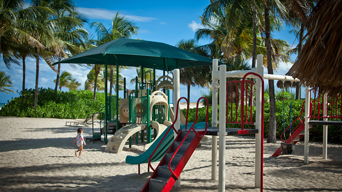 A small child enjoying the beach playground at the Lago Mar Beach Resort & Club.