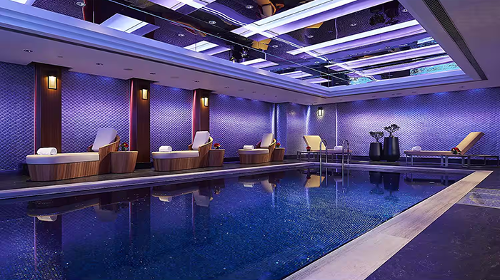 The Mandarin Oriental, Hong Kong's indoor pool. The room features bold purple lighting.