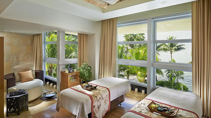 A massage room inside the Mandarin Oriental Hotel in Miami. Large windows allow a view of the water in addition to letting in lots of natural light.