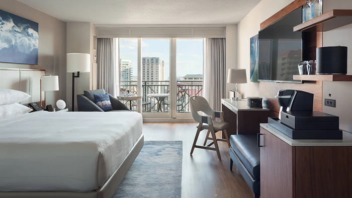 A guest room at Tampa Marriott Water Street. This one features a balcony where guests can enjoy some fresh air.