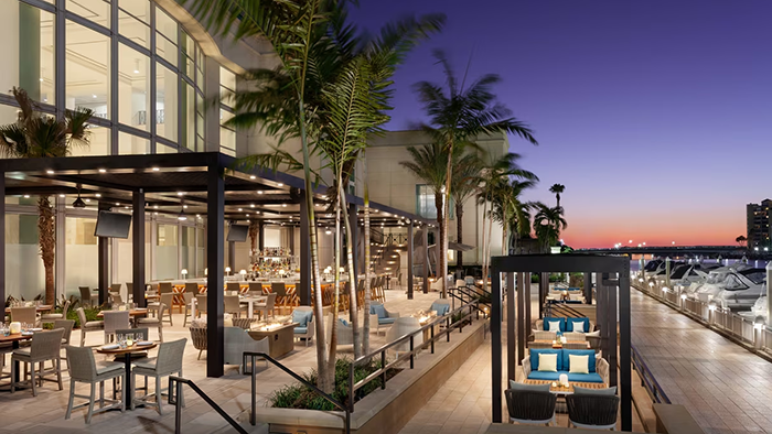 An outdoor restaurant at the Tampa Marriott Water Street hotel. This photo looks like it was taken just after sunset.