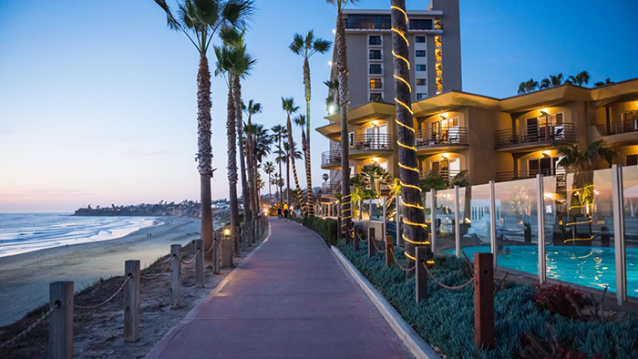 An image of the sidewalk between the Pacific Terrace Hotel and the Pacific Ocean in San Diego, California.
