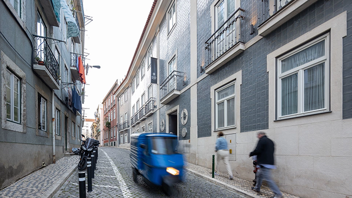 The outside of the Lisboa Pessoa Hotel in Lisbon, Portugal. It's located on a quaint little street.