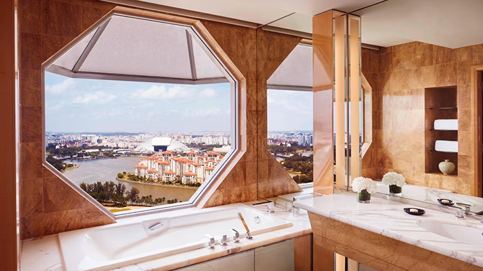 An en-suite bathroom at The Ritz-Carlton Millenia Singapore hotel. Guests staying in this room can enjoy an incredible view of Singapore from the comfort of their bathtub.
