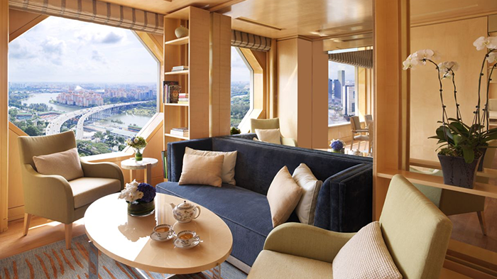 A guest suite at The Ritz-Carlton Millenia Singapore hotel. Two cups of tea are sitting on the coffee table waiting to be enjoyed.