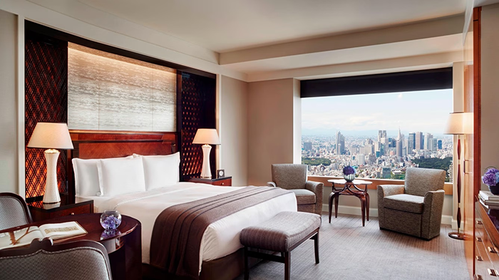 A guest room at The Ritz-Carlton, Tokyo. A large window allows those that stay at the hotel to enjoy incredible views of Tokyo.