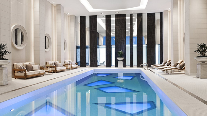 The indoor pool at the Rosewood Hotel Georgia in Vancouver. The room is very well lit, and the ceiling is notably high.