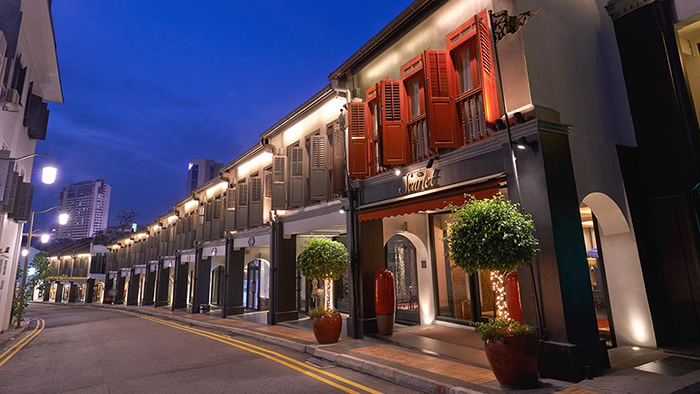 An image of the exterior of The Scarlet hotel in Singapore. The red accents make the establishment stand out from its neighbors.