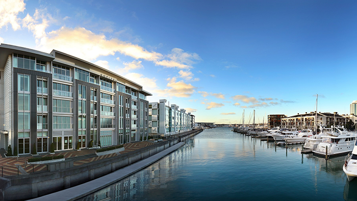 An exterior image of Sofitel Auckland Viaduct Harbour during the day. Viaduct Harbour is prominently visible, as one might expect.
